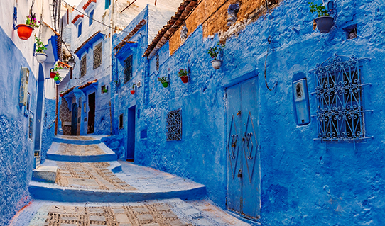 traditional old blue street with color pots inside Medina of Chefchaouen, Morocco